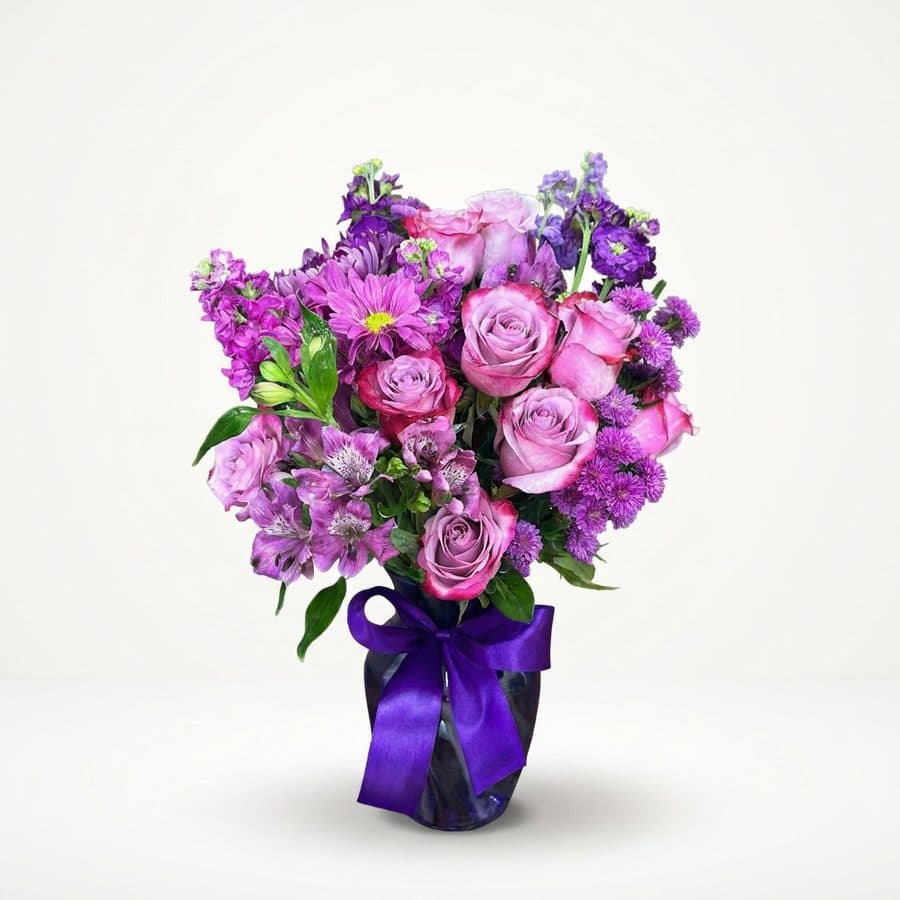 After: purple roses and mums in a glass vase, BloomShot product photo